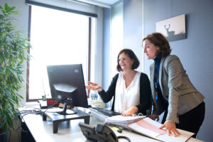 Two people looking at a screen